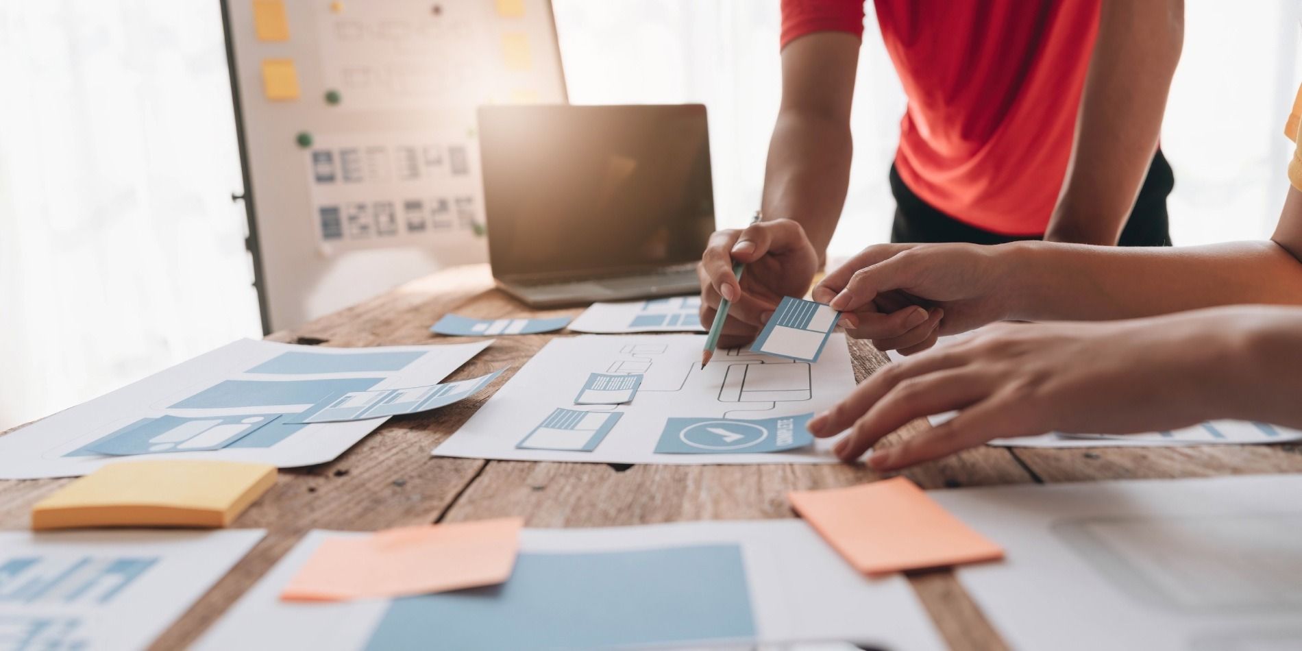 Un grupo de personas está sentada en una mesa trabajando en un proyecto.